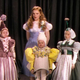 Hair and costume test for a blonde Judy Garland with three dispirited Munchkins,